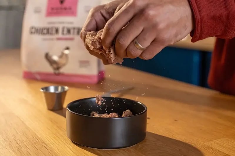 freeze-dried-dog-food-being-crumbled-into-bowl