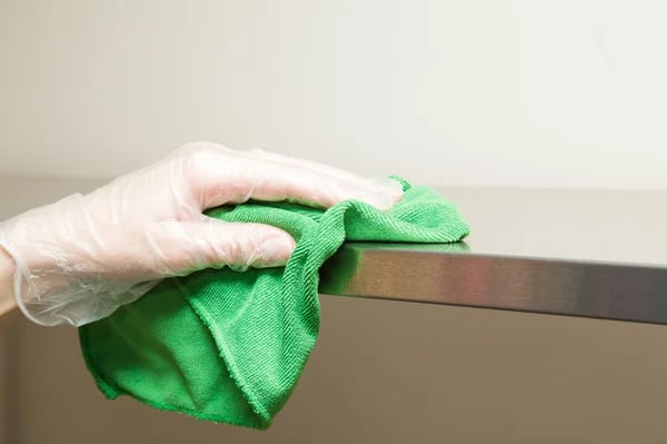 hand-disinfecting-table-counter-surface